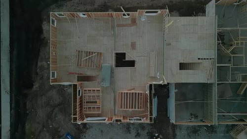 Aerial Above View the a New House Under Construction Wood Framing Beams at Sunny Day