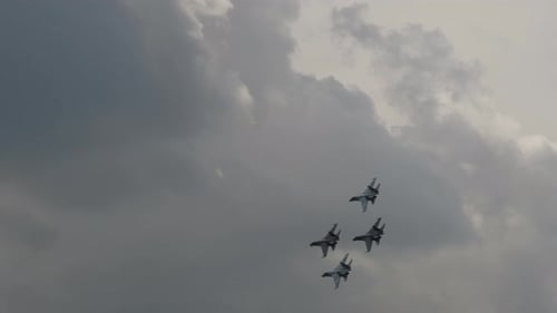 Fighter Jets Fly in Formation Against Cloudy Sky