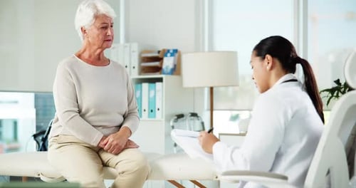 Senior Woman Talking to Doctor in Bright Office