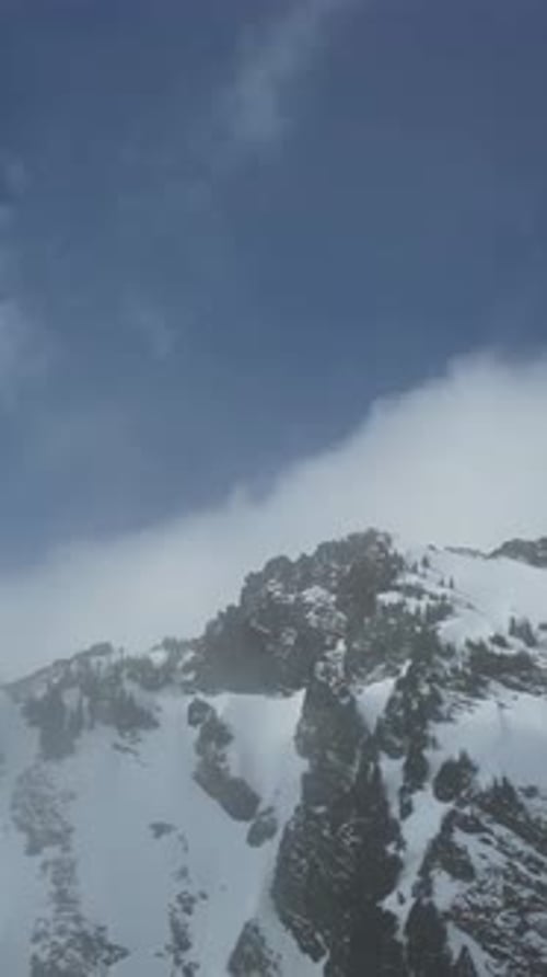 Snowy Mountain Peak. Blue sky, clouds. British Columbia, Canada.