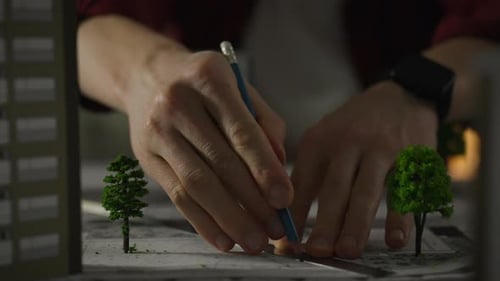 A European-born design engineer carefully develops design drawings in a design studio, paying