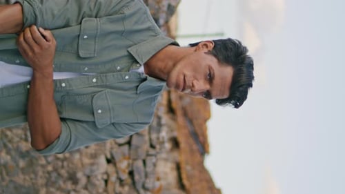 Man Rolling up Sleeves Outside During the Day