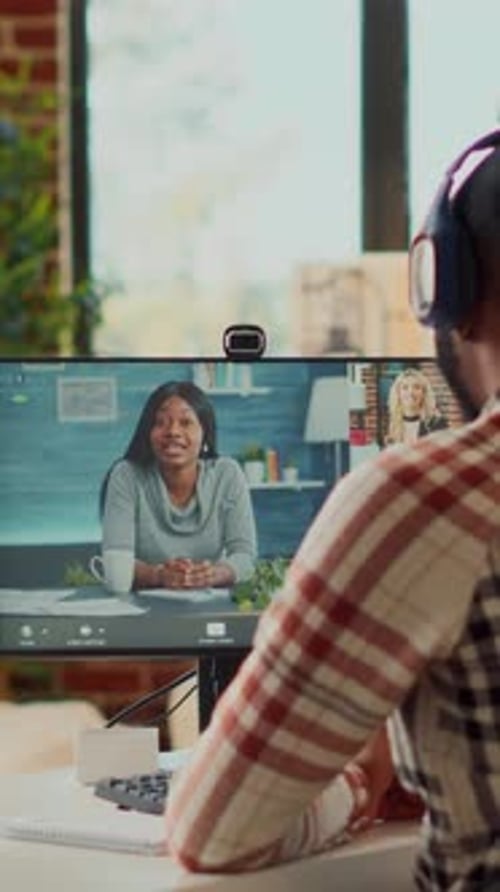 Man Attending Video Conference Call on Desktop Computer