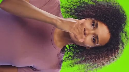 Young Cute Casual African American Woman Blows Kiss to Camera Stands in Studio