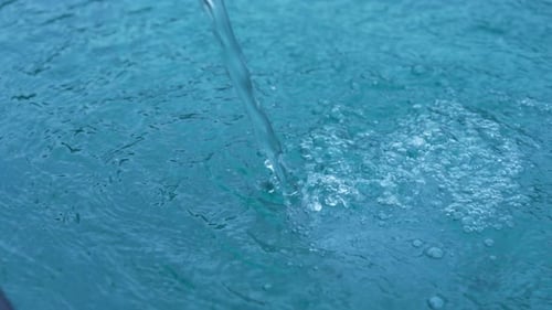 Water Flowing Into a Small Blue Pool