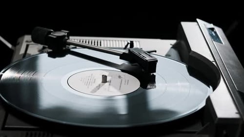 Turntable Needle Drop on a Spinning Vinyl Record to Playing Music Close Up
