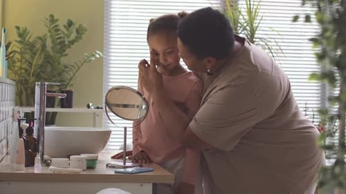 Woman and Child Bond in Bathroom Vanity Scene