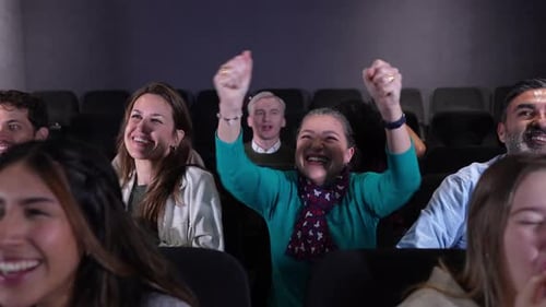 Audience Cheering and Applauding Sport Match in Slow Motion at Theater