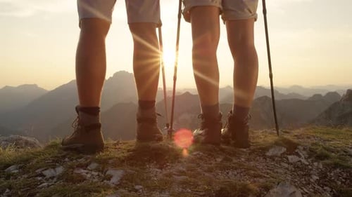 woman and man stand on the mountain peak