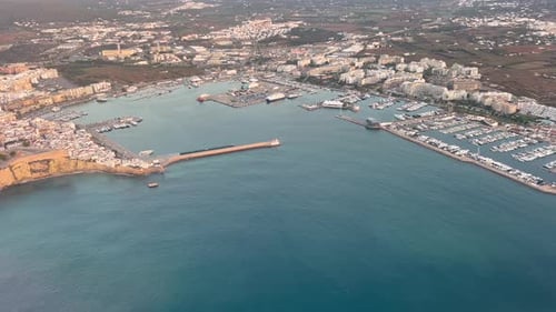 Ibiza City, Balearic Islands, Spain. Aerial side view of the city and harbor recorded from a plane