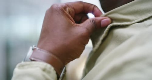 Man Adjusts Shirt Collar Close Up