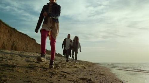 Family beach holiday blissful parents and child walking on ocean coast landscape