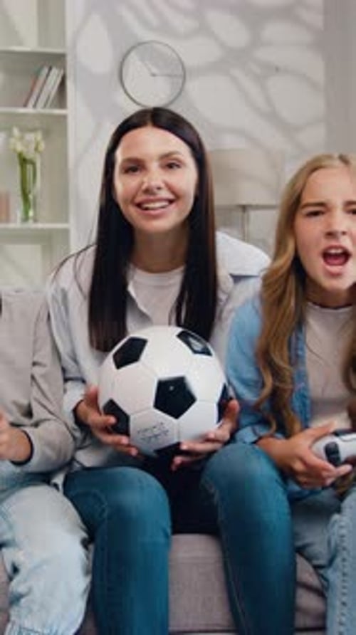 Family of Four Cheering While Playing Video Games