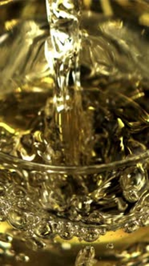 Golden Champagne Pours Into a Glass with Air Bubbles Filmed is Slow Motion 1000 Frames Per Second