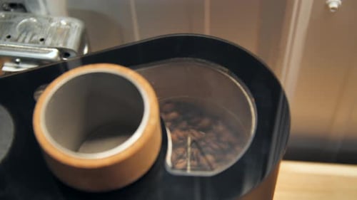 Coffee beans spinning in a drum roaster, slow motion close up