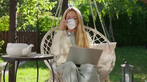 Middle Aged Woman Working Remotely Outdoors on Terrace