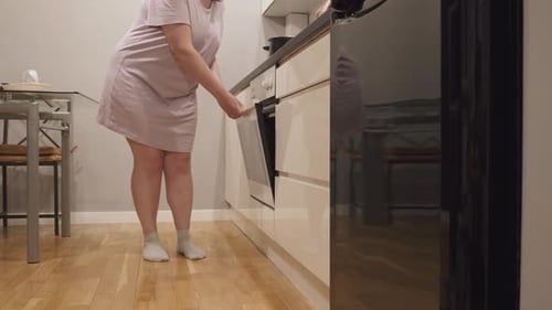 Plus Size Woman with Effort Open Oven Door Door is Broken
