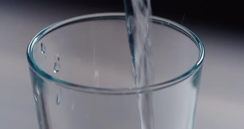 Water Being Poured into Glass in Close Up