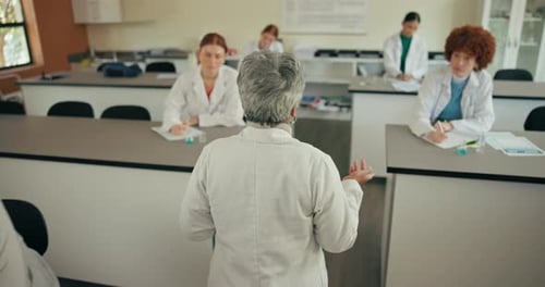 School, science and teacher with students in classroom for learning, education and chemistry lesson