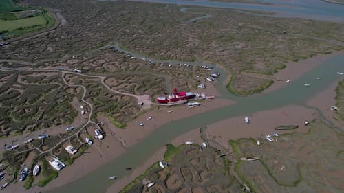 Aerial view over the stranded LV15 Trinity Lightvessel, sunny Tollesbury, UK - tilt, drone shot
