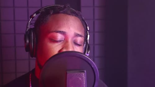Singer is Recording New Song in Professional Audio Record Studio Closeup Portrait of Black Man