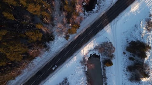 Experience a Stunning Scenic Winter Drive Featuring an Aerial View of a Snowy Road Winding Through a