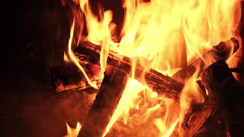 Fire Burning Brightly in a Dark Fireplace