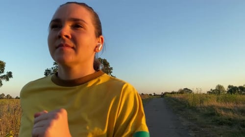 Female portrait with copy space while jogging in serene outdoors
