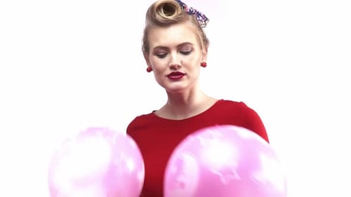 Woman Smiling Holding Balloons at Birthday Party