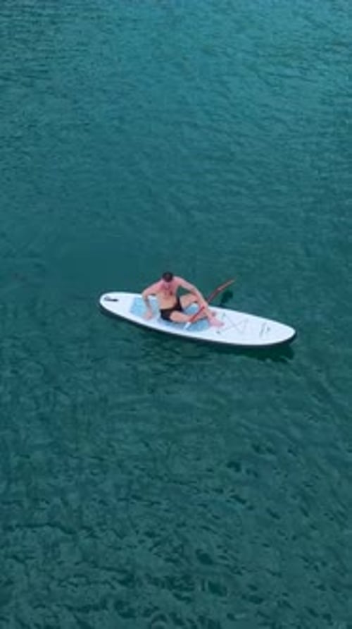 Vertical Video Scenic Paddleboarding in a Canyon with Friends Relaxing Swimming and Enjoying