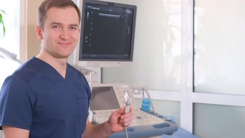 Smiling Doctor with Ultrasound Machine in Hospital