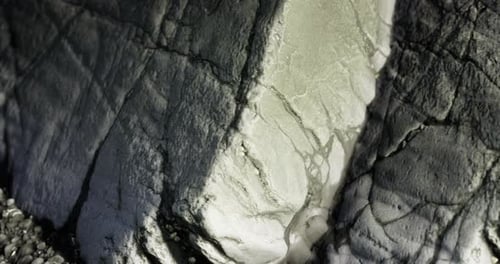 Intricate Patterns on a Rugged Rock Face Illuminated By Soft Light