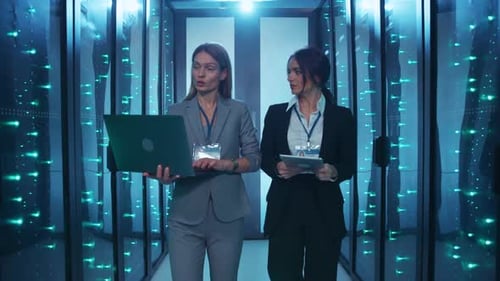 Women Working Confidently in a Futuristic Server Room