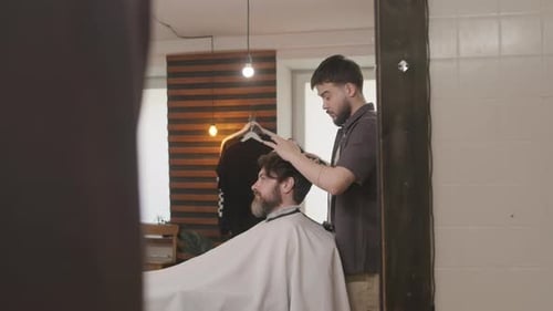 Barber Styling Customer's Hair with Comb and Dryer