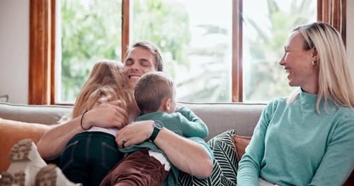 Loving Family Cuddling on the Sofa at Home