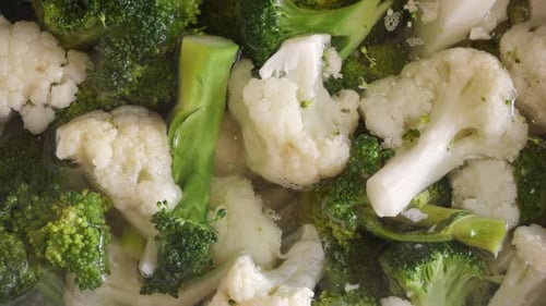Macro shot of cooking broccoli and cauliflower in hot water
