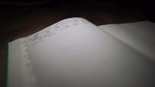 Close up of Open Notebook Pages Being Turned