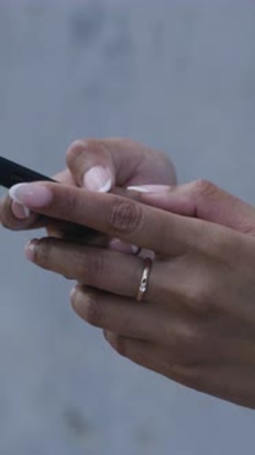 Hands, typing and woman in city with phone for social media, networking and internet on weekend