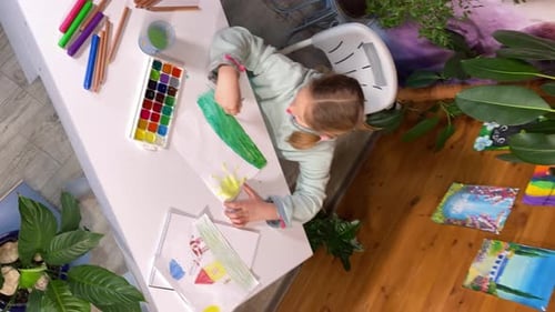 Young Artist Creative Watercolor Painting in Indoor Setting