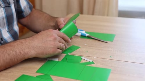 Man's Hands Assembling a Paper Box Close Up