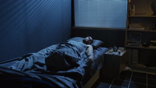 Distressed Man Wakes Up in Dark Bedroom