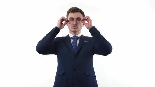Man in Suit Removes Glasses, Makes Stop Gesture
