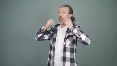 Man Fanning Himself, Feeling Overheated in Studio