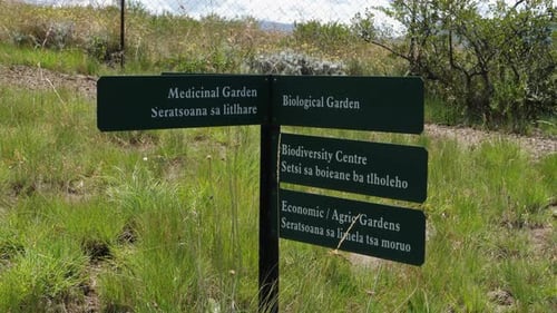 Garden sign post in English and Sesotho languages, Lesotho Africa