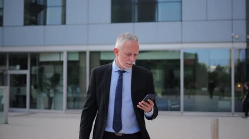 Determined Businessman Rushing to an Important Meeting While Holding a Cup of Coffee in Hand
