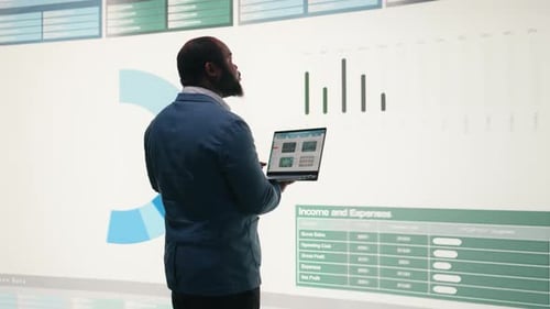 Analyzing Revenue Laptop and Manager Looking at Expenses