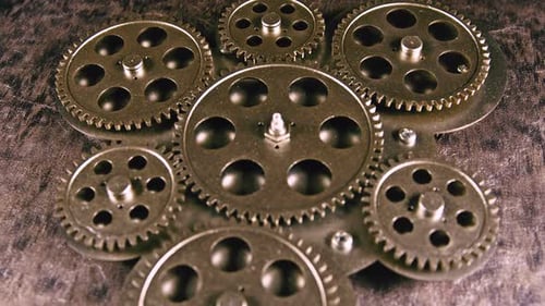 Metallic Gears Rotating Slowly on Textured Surface