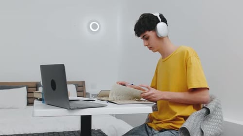 Young Adult Studying with Laptop and Headphones