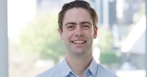 4k video footage of a handsome young businessman standing alone in his office during the day