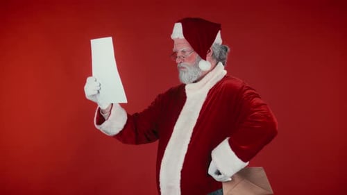 Santa Claus Reads Naughty List on Red Background